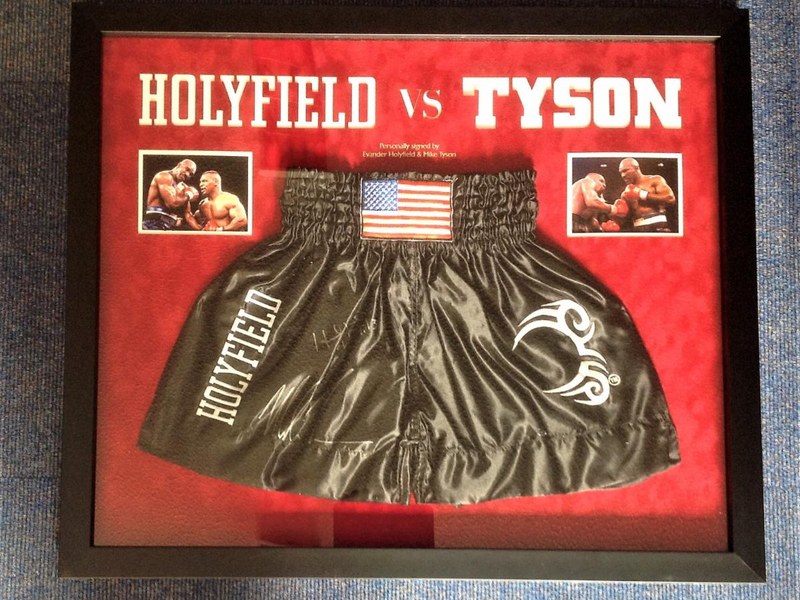 A signed Holyfield vs Tyson boxing shorts display